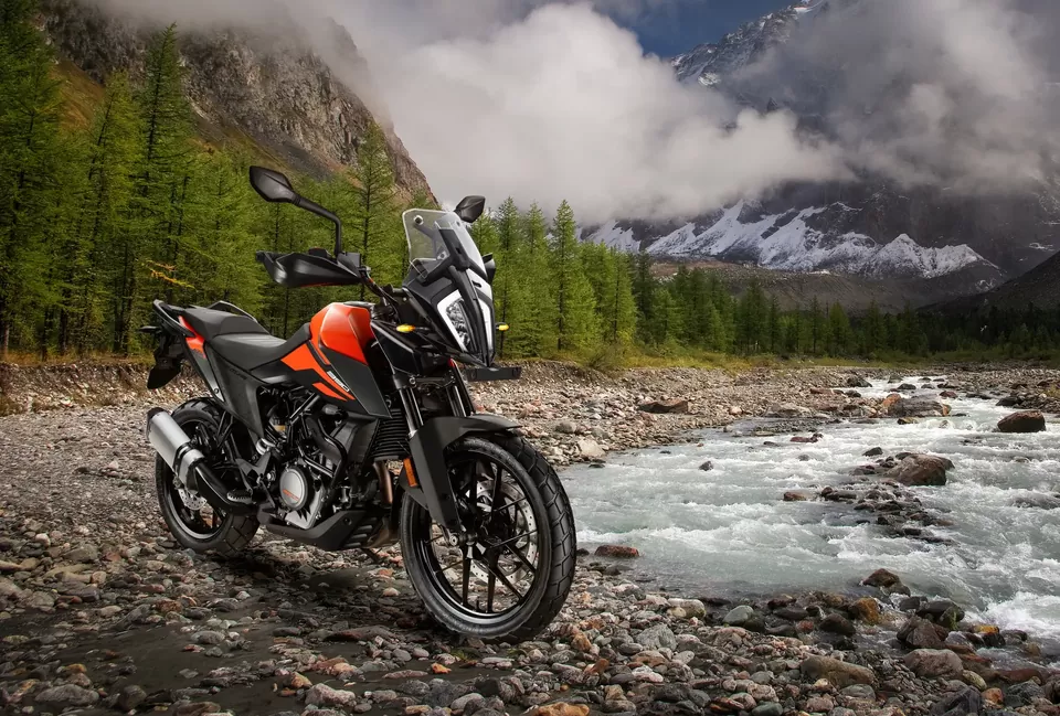 Adventure motorcycle beside a mountain stream