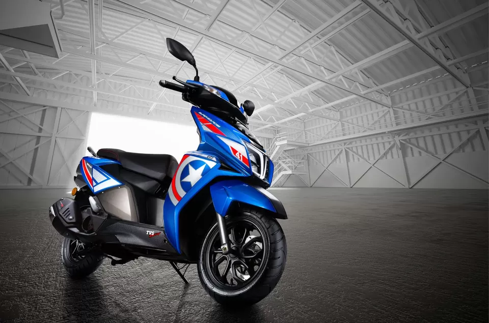 Blue scooter photographed in a bright industrial setting