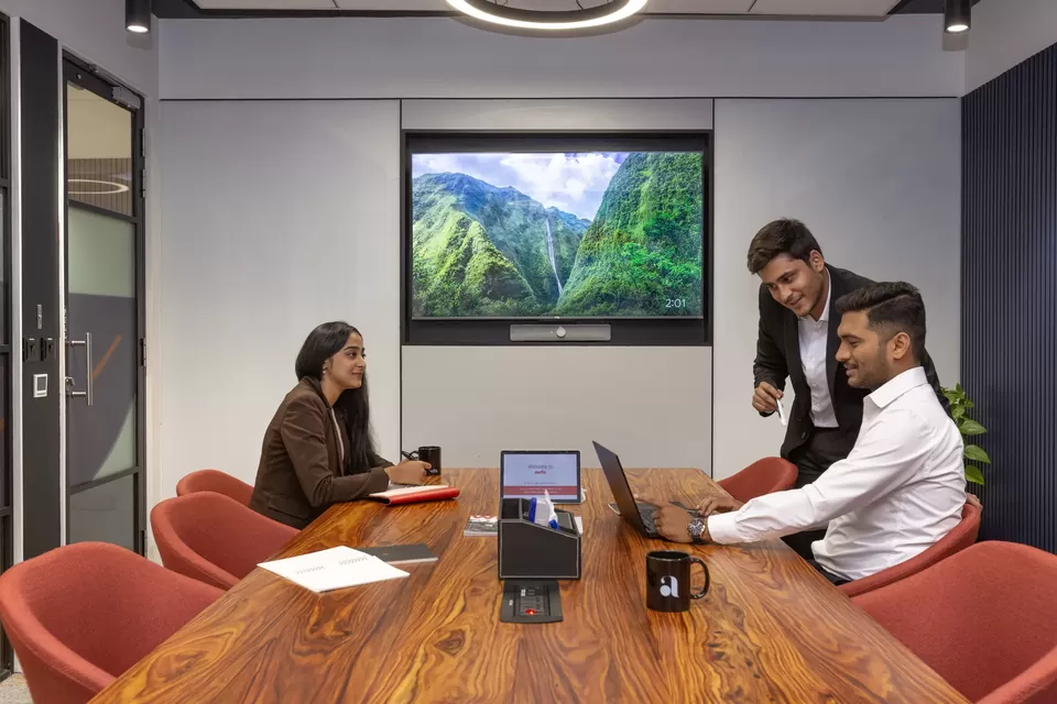 Three colleagues working around a table in a contemporary office